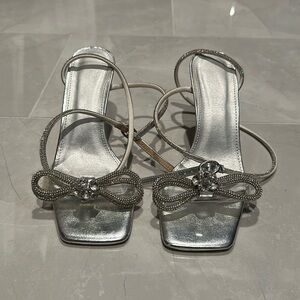 Silver high heels with bow detail